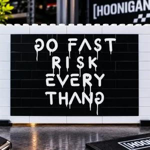 Hoonigan Style "Go Fast" on Black background depicted on our BRICKSAW ™ Lego compatible Brick wall